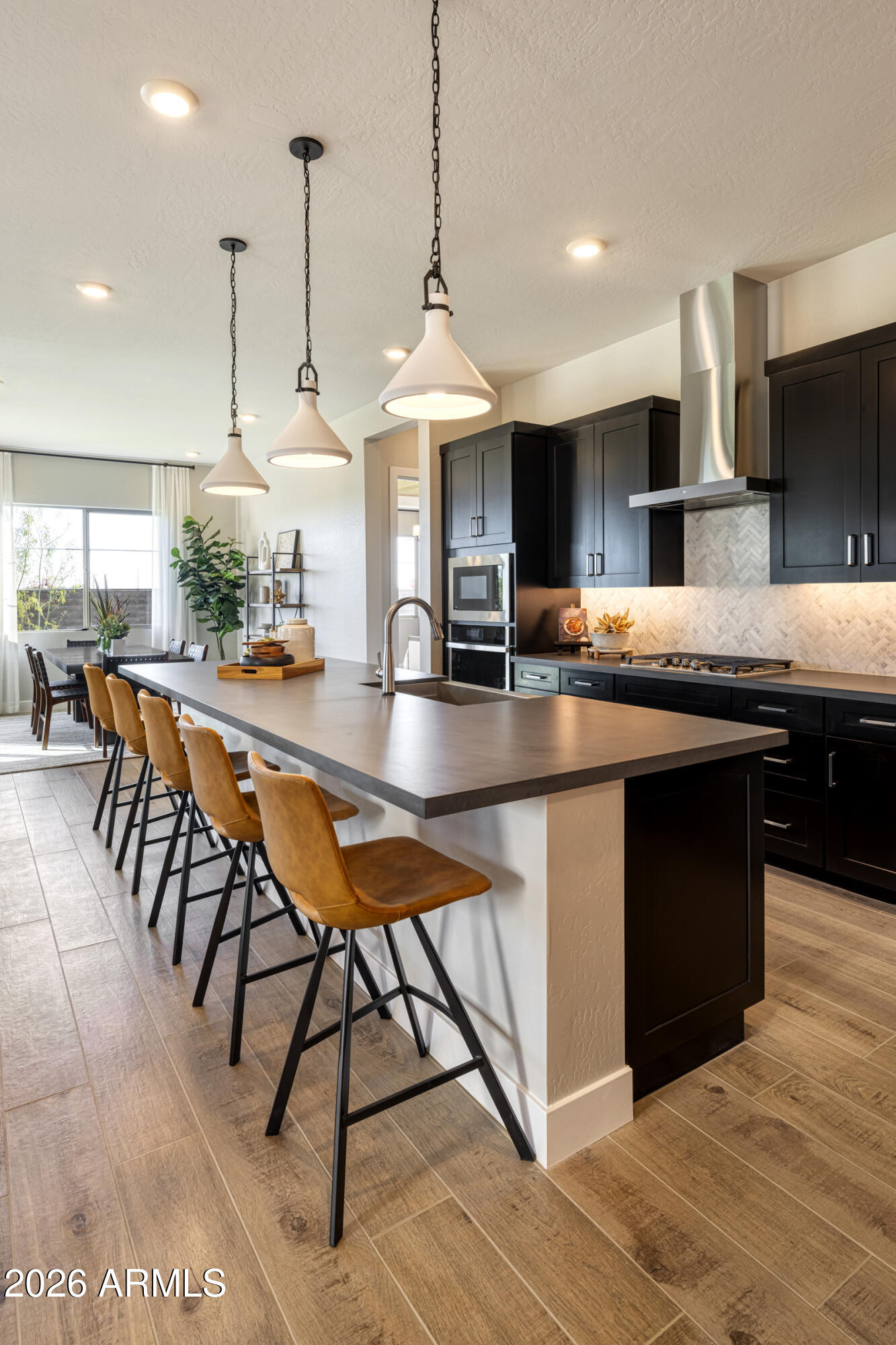 5737 South Quartz Street Gilbert, AZ 85298 - Photo 5 of 15 a kitchen with stainless steel appliances granite countertop a stove a sink dishwasher and a wooden cabinets with large window