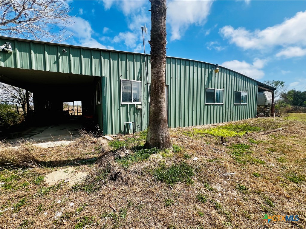 607 Quail Meadow Road Seadrift, TX 77983 - Photo 11 of 48 a backyard of a house with a garden