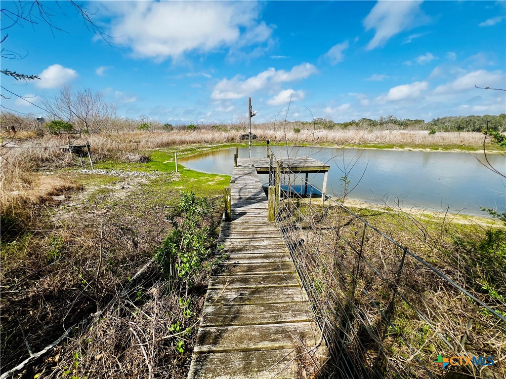 607 Quail Meadow Road Seadrift, TX 77983 - Photo 25 of 48 a view of a lake with houses in the back