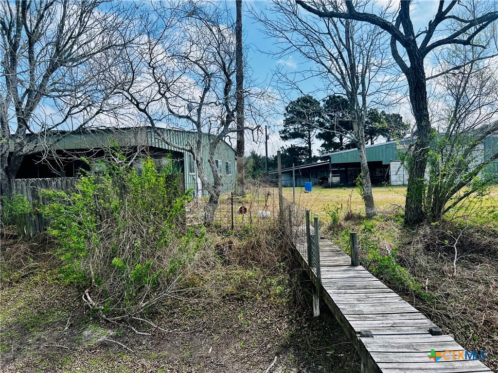 607 Quail Meadow Road Seadrift, TX 77983 - Photo 28 of 48 a view of a house with large trees and a yard