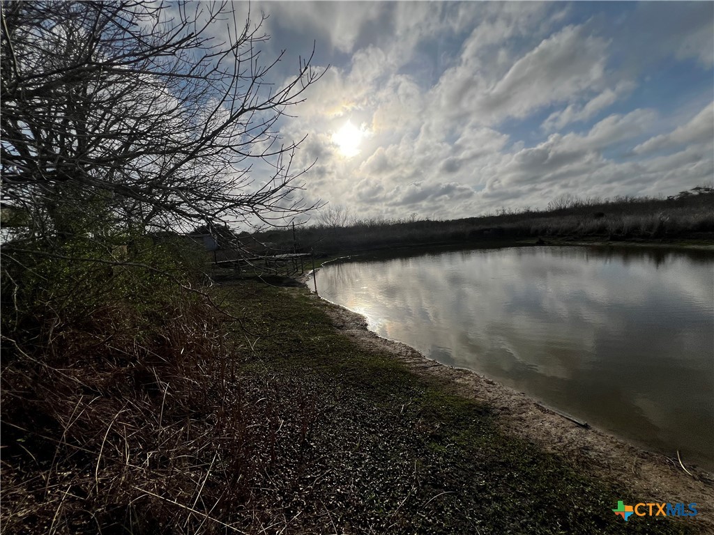 607 Quail Meadow Road Seadrift, TX 77983 - Photo 4 of 48 a view of a lake from a yard
