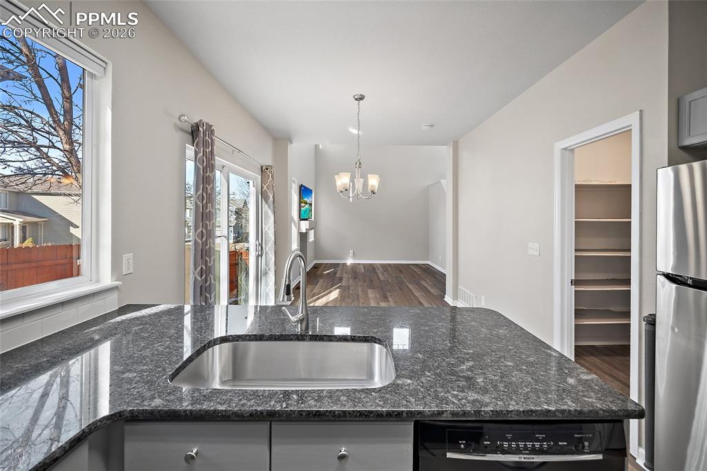 855 Dawn Break Loop Colorado Springs, CO 80910 - Photo 19 of 42 a kitchen with granite countertop a sink and a granite counter tops