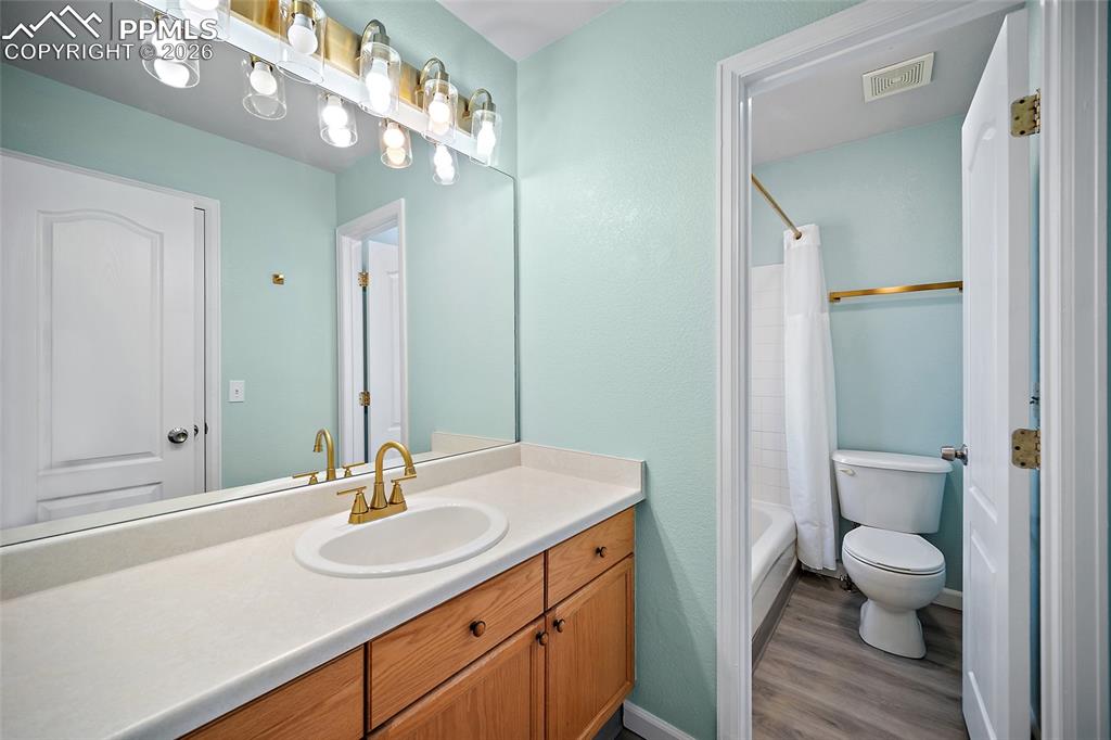 855 Dawn Break Loop Colorado Springs, CO 80910 - Photo 24 of 42 a bathroom with a sink a toilet and a mirror
