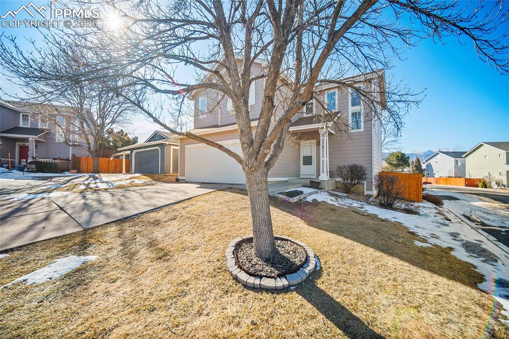 855 Dawn Break Loop Colorado Springs, CO 80910 - Photo 3 of 42 a front view of a house with a yard covered with snow