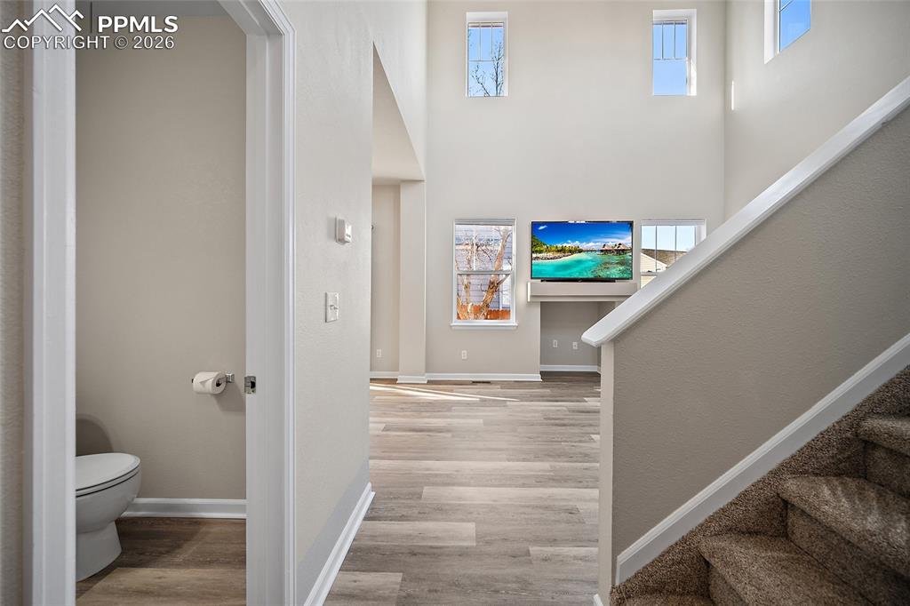 855 Dawn Break Loop Colorado Springs, CO 80910 - Photo 5 of 42 a view of a hallway with wooden floor and staircase