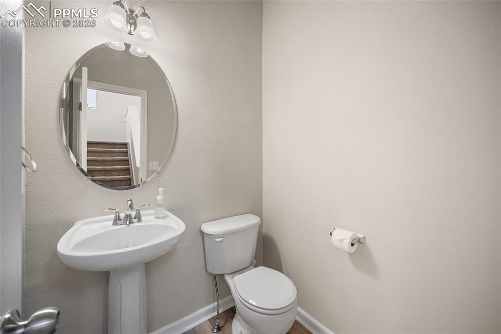 855 Dawn Break Loop Colorado Springs, CO 80910 - Photo 6 of 42 a bathroom with a toilet a sink and mirror