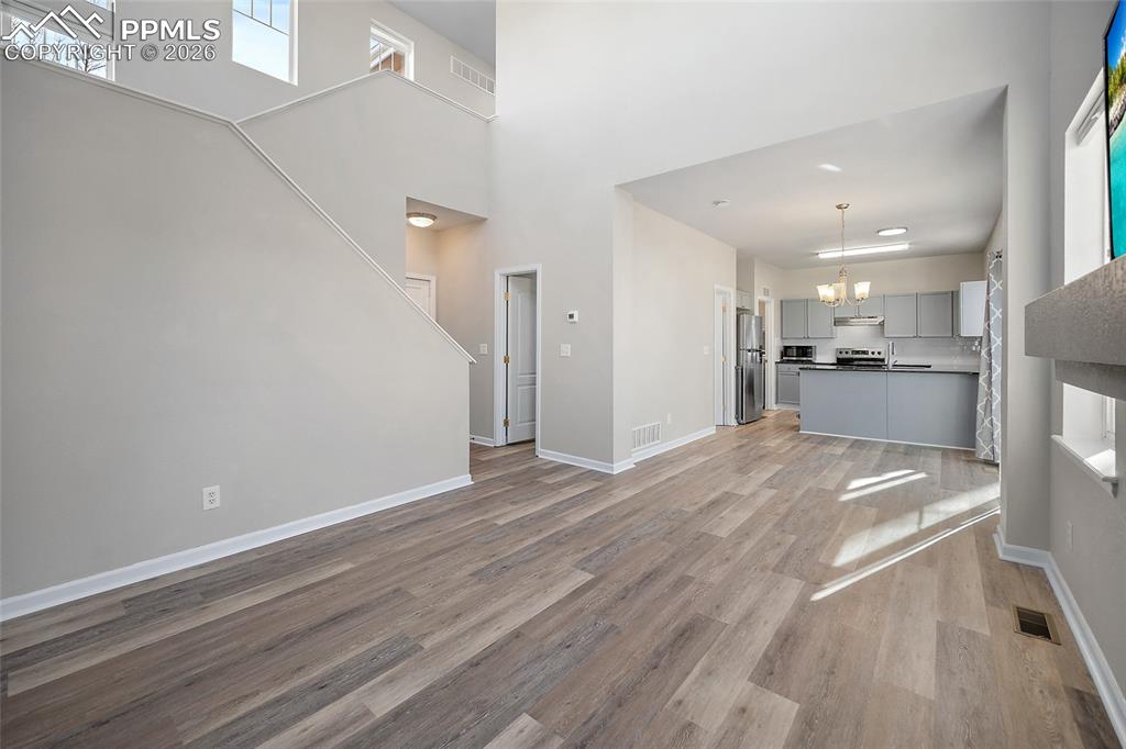 855 Dawn Break Loop Colorado Springs, CO 80910 - Photo 9 of 42 a view of a kitchen with a fridge and wooden floor