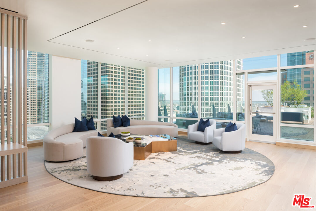 1000 West 8th Street, Unit PH5803 Los Angeles, CA 90017 - Photo 32 of 57 a living room with furniture and a large window