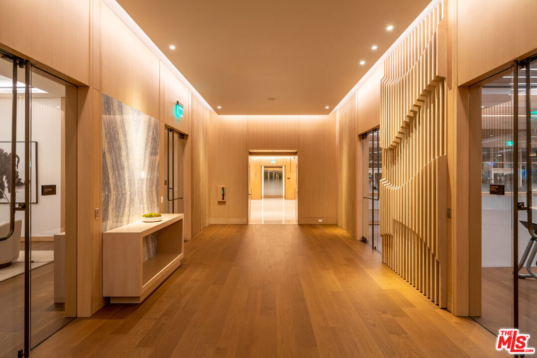1000 West 8th Street, Unit PH5803 Los Angeles, CA 90017 - Photo 42 of 57 a view of a hallway with wooden floors and refrigerator