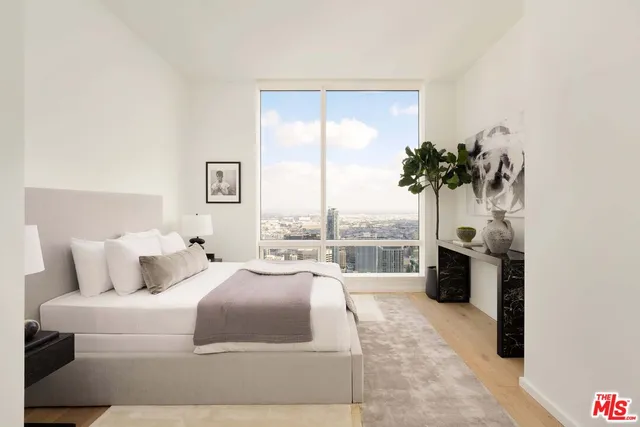 a bedroom with a large bed and a balcony view