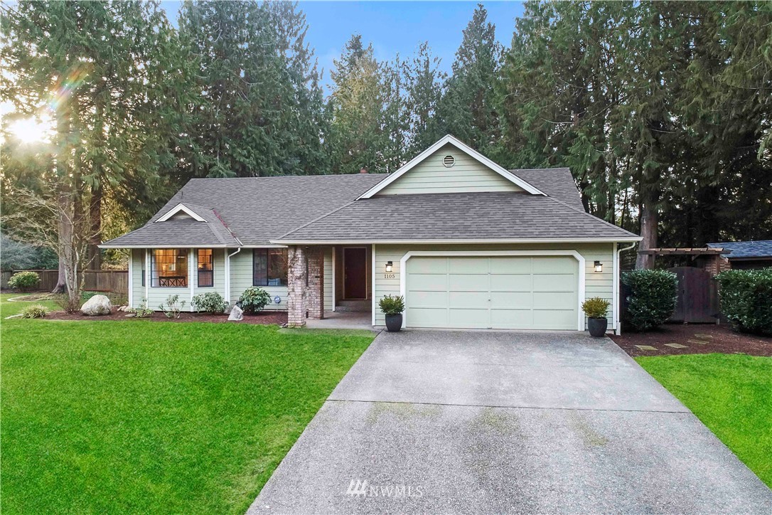 1105 289th Avenue Northeast Carnation, WA 98014 - Photo 1 of 19 a front view of a house with a yard and garage