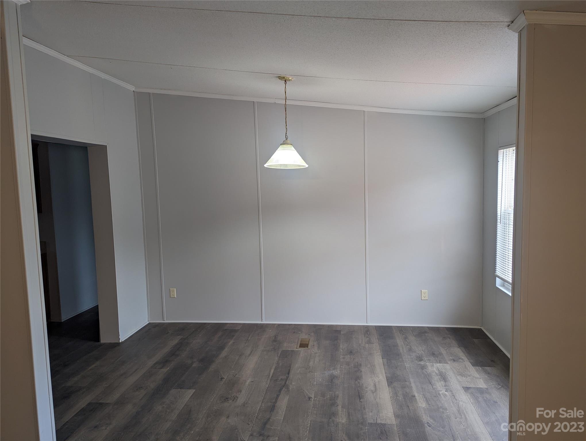 4261 Henry Dellinger Road Maiden, NC 28650 - Photo 4 of 5 a view of an empty room with wooden floor and a window