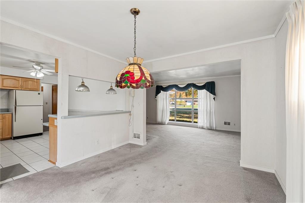8324 Lamor Road Mercer, PA 16137 - Photo 9 of 30 a view of a kitchen with a refrigerator and a ceiling fan