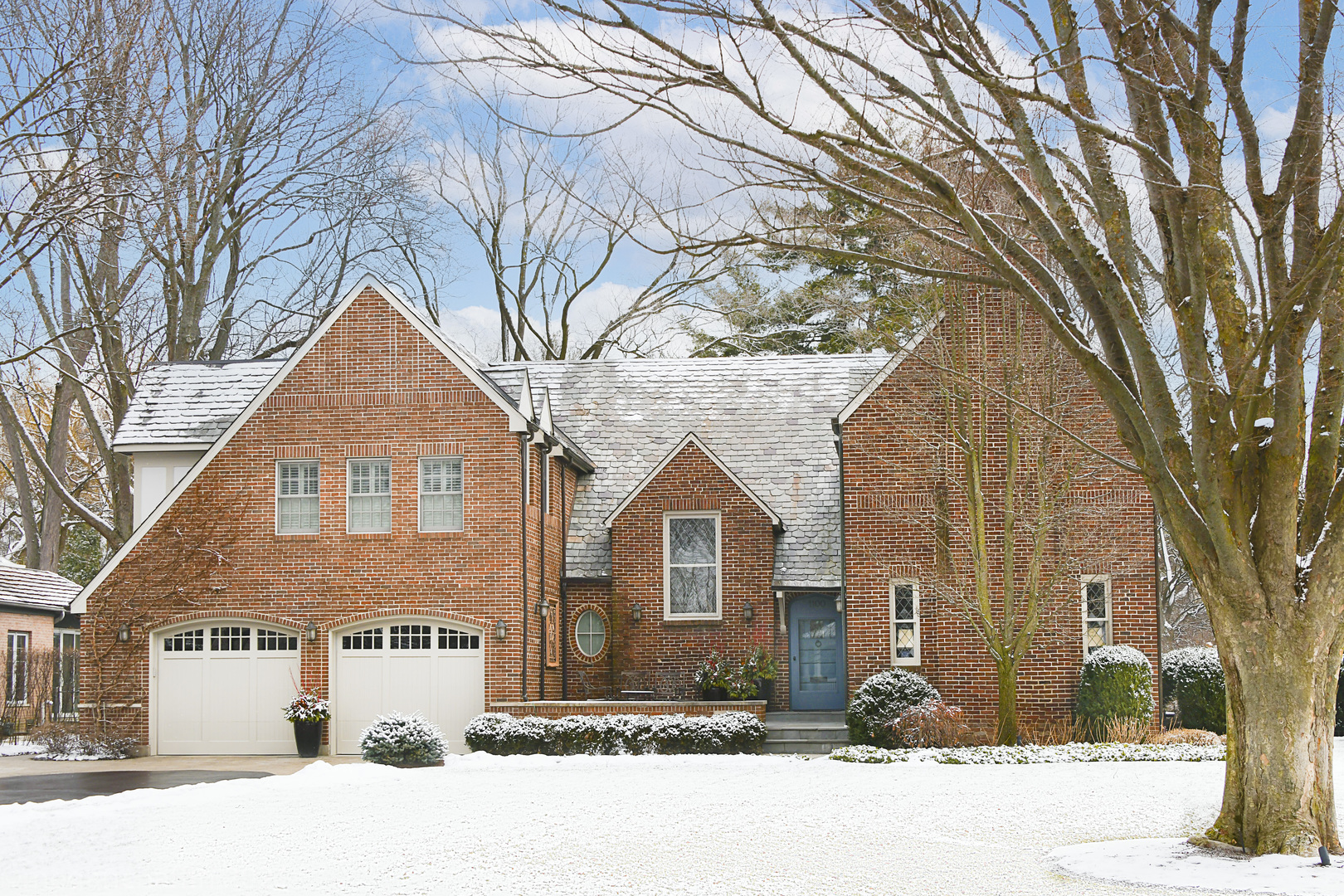 1100 Mohawk Road Wilmette, IL 60091 - Photo 1 of 2 a front view of a house with a yard covered in snow