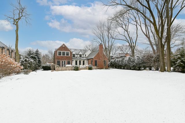 a view of houses with snow on the road