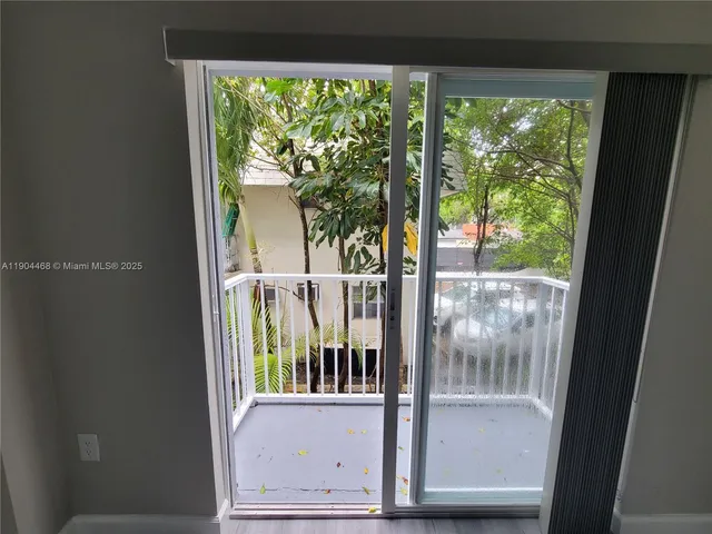 an empty room with closet and a bathroom