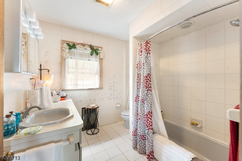 1321 Murray Avenue Plainfield, NJ 07060 - Photo 7 of 13 a bathroom with a sink toilet and shower