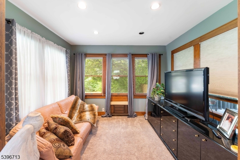 1321 Murray Avenue Plainfield, NJ 07060 - Photo 10 of 13 a living room with furniture and a flat screen tv