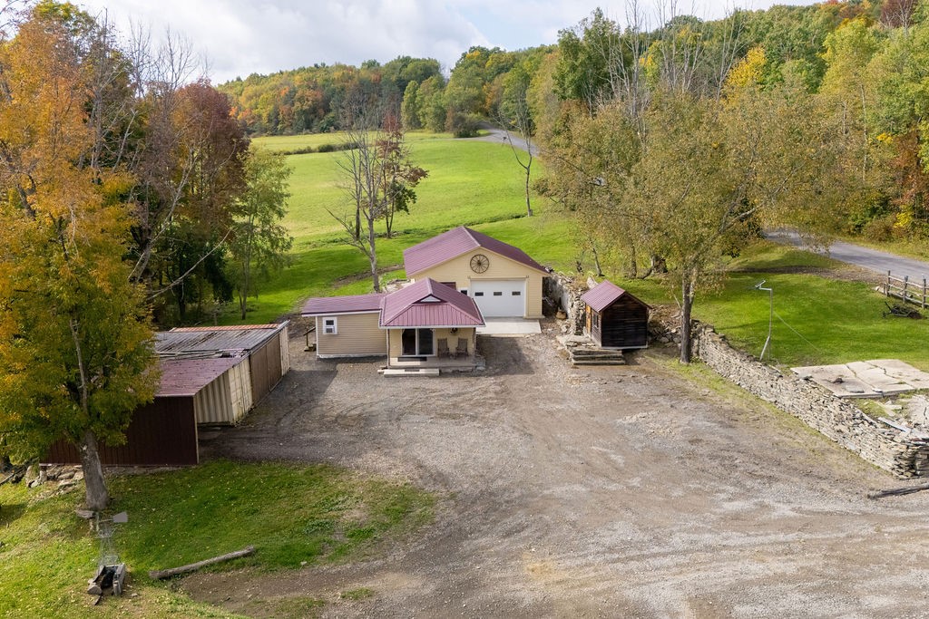 1668 Vandervort Hill Road Unadilla, NY 13849 - Photo 33 of 50 Nestled among mature trees, this countryside property features multiple functional outbuildings and rolling green hills.