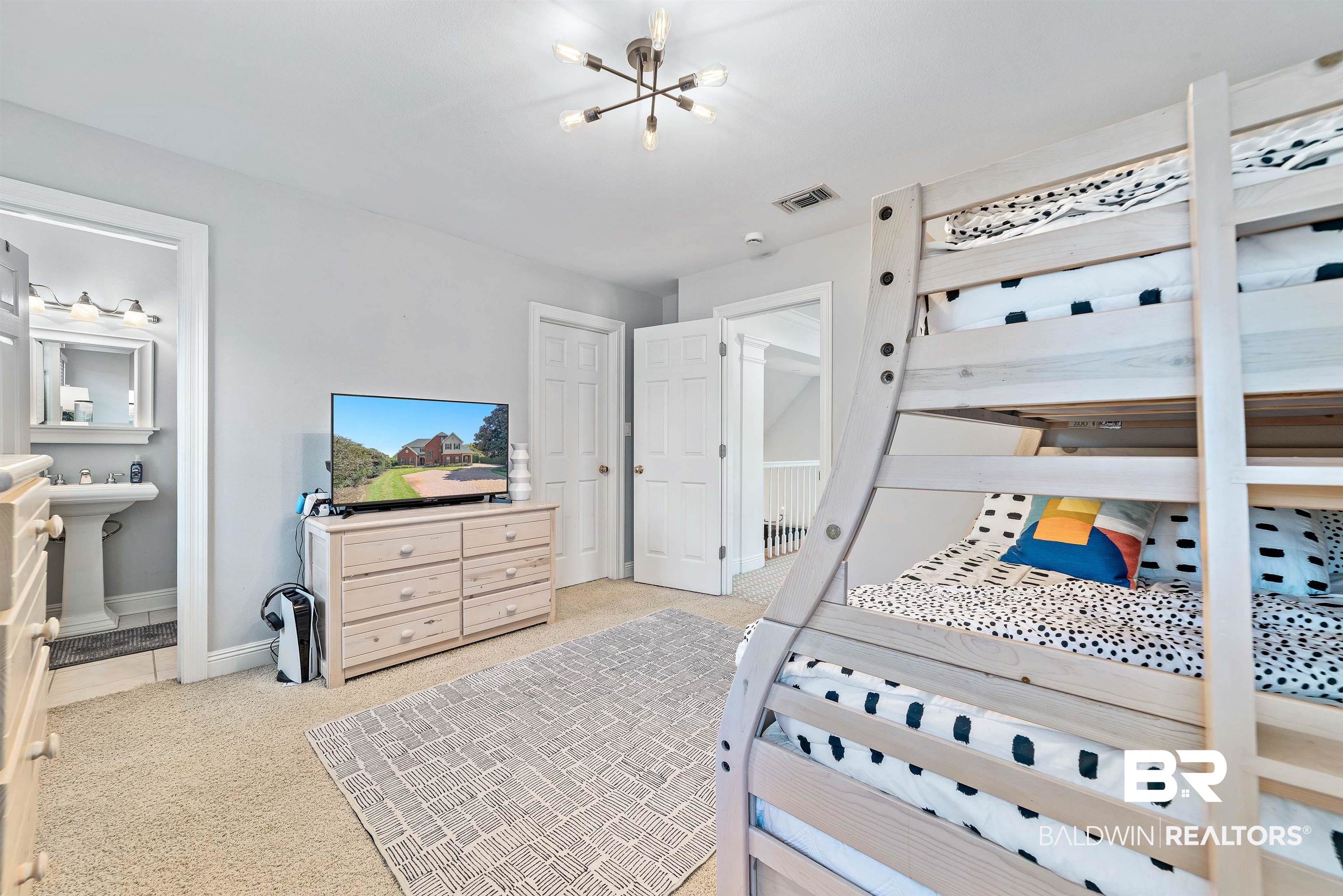 6630 East Quarry Drive Elberta, AL 36530 - Photo 36 of 63 Bedroom featuring light colored carpet, a chandelier, and ensuite bath