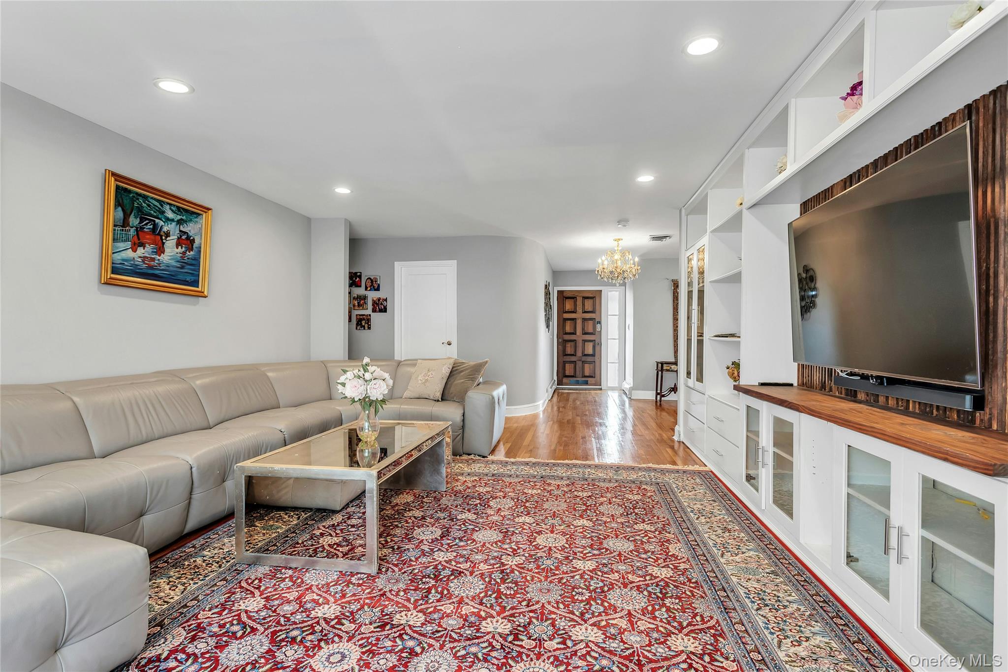 170 Old Courthouse Road Manhasset Hills, NY 11040 - Photo 15 of 35 Living area featuring LED lighting, hardwood floors, and built-in wall unit features