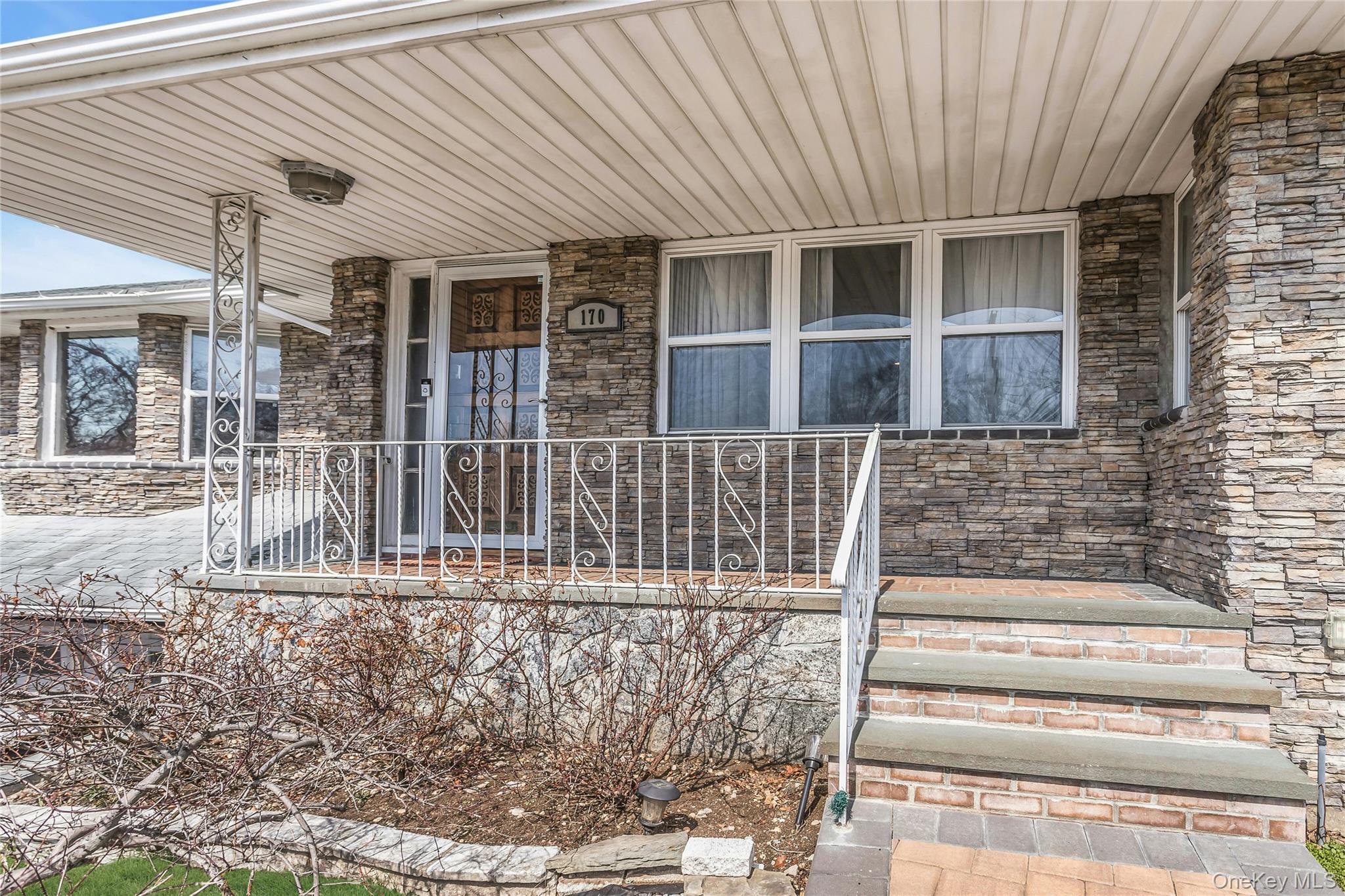 170 Old Courthouse Road Manhasset Hills, NY 11040 - Photo 2 of 35 Property entrance featuring covered porch and stone facade