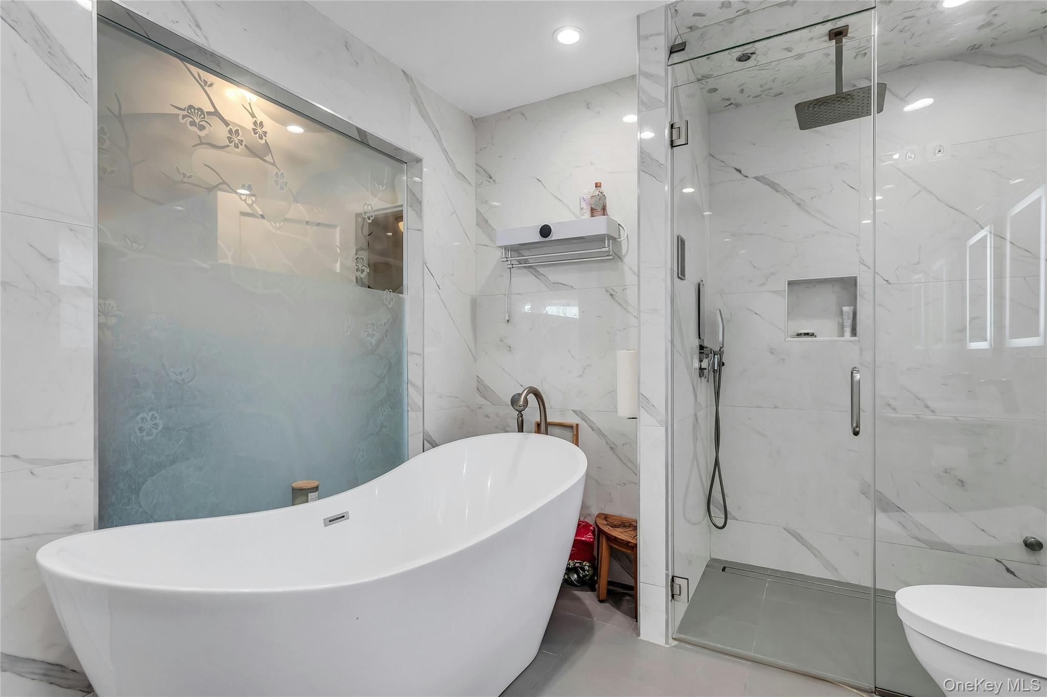 170 Old Courthouse Road Manhasset Hills, NY 11040 - Photo 21 of 35 Full bath featuring double vanity, a marble finish shower, stone wall, recessed lighting, and a soaking tub