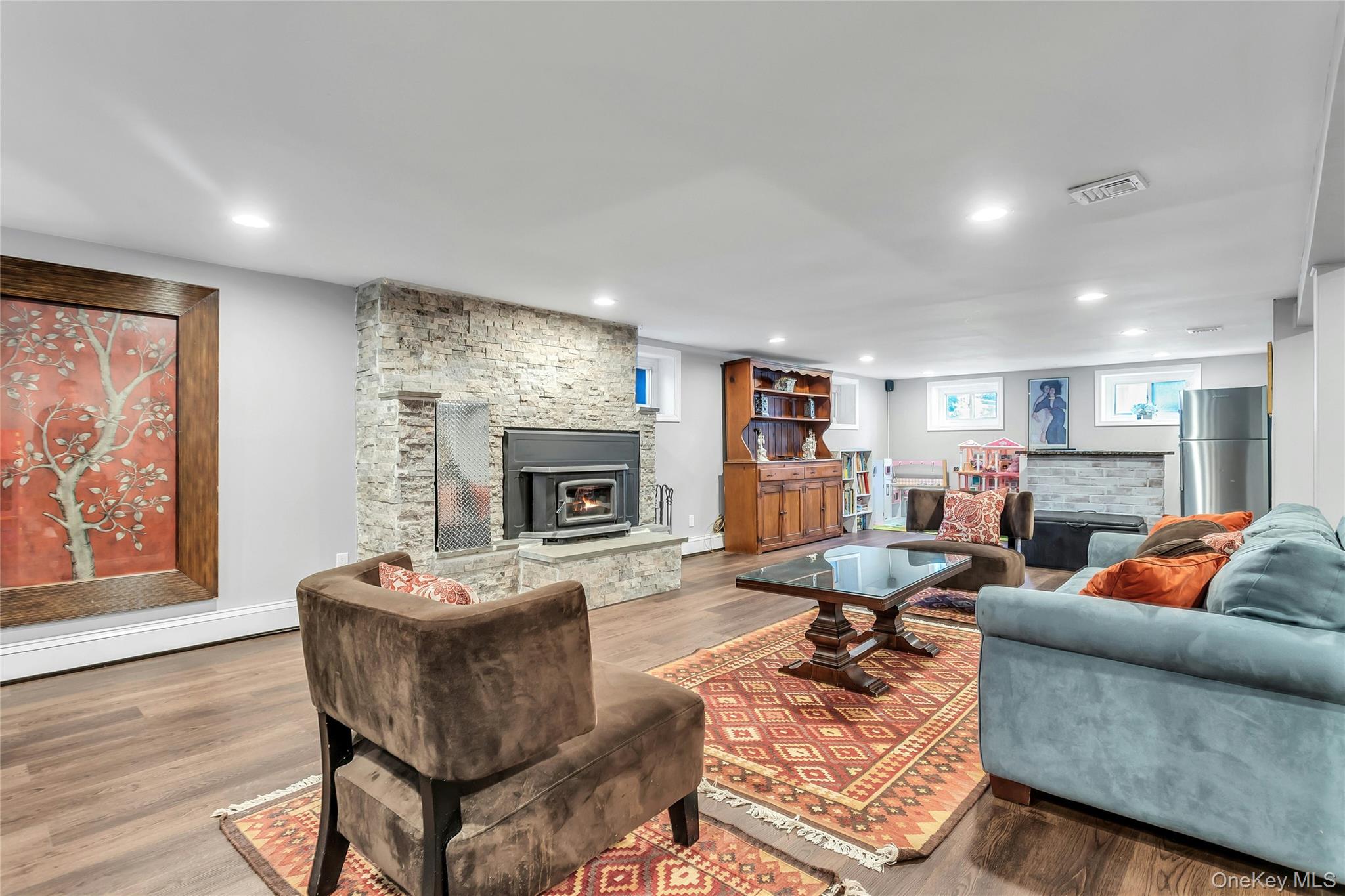 170 Old Courthouse Road Manhasset Hills, NY 11040 - Photo 25 of 35 Lower Level Family Room, fireplace insert, wet bar, wood finished floors, and recessed lighting