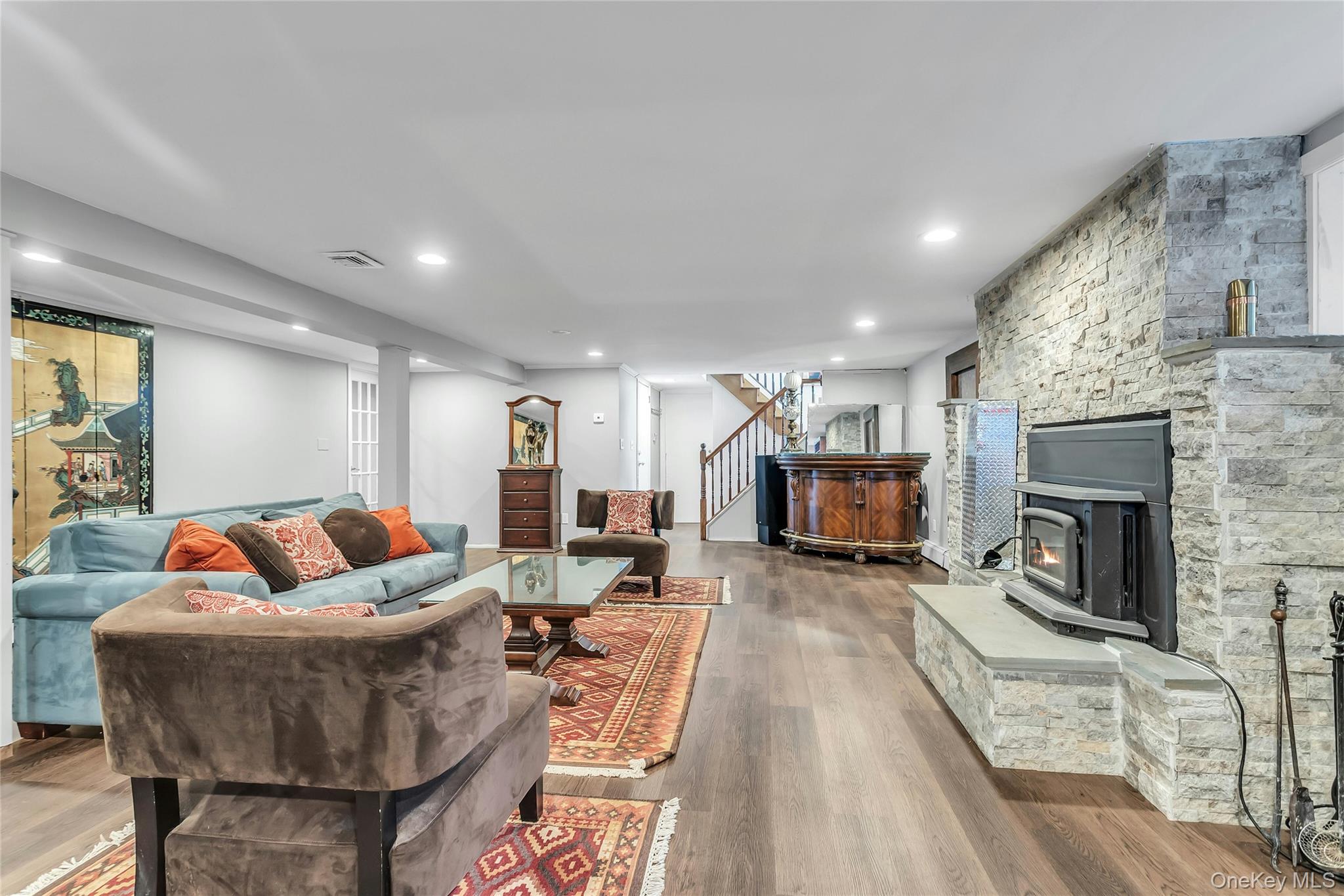 170 Old Courthouse Road Manhasset Hills, NY 11040 - Photo 26 of 35 Lower Level Family Room, fireplace insert, wood finished floors, and recessed lighting