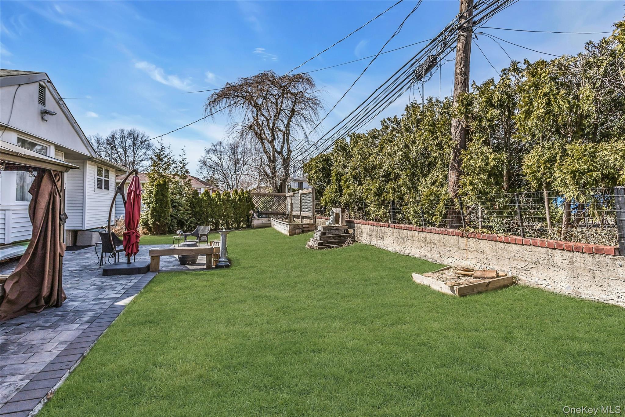 170 Old Courthouse Road Manhasset Hills, NY 11040 - Photo 33 of 35 Beautifully manicured backyard, retaining wall, room for a pool, great fro entertaining and just relaxing, gifted Storage shed