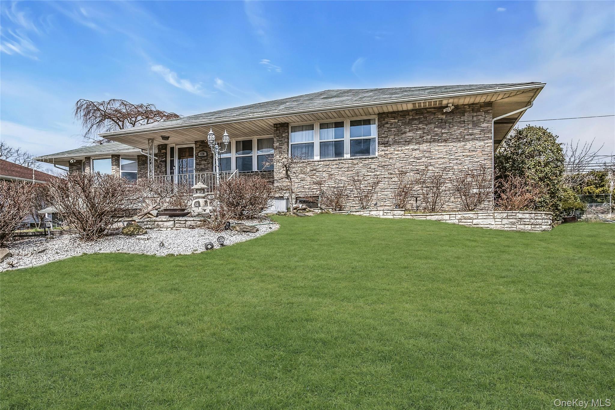 170 Old Courthouse Road Manhasset Hills, NY 11040 - Photo 35 of 35 View of front of house featuring a front yard and covered porch