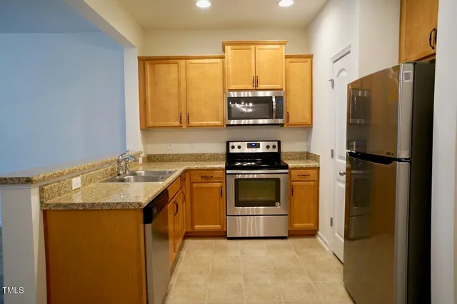 a kitchen with a sink appliances and cabinets