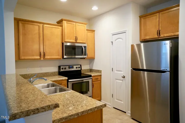 a kitchen with a refrigerator sink and stove