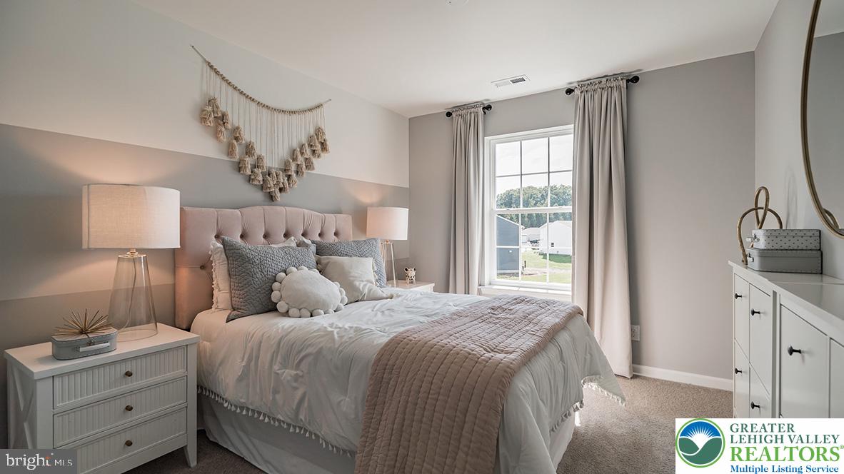115 Winding Road Easton, PA 18040 - Photo 14 of 24 This cozy bedroom offers a restful sanctuary with a window view and inviting textures.