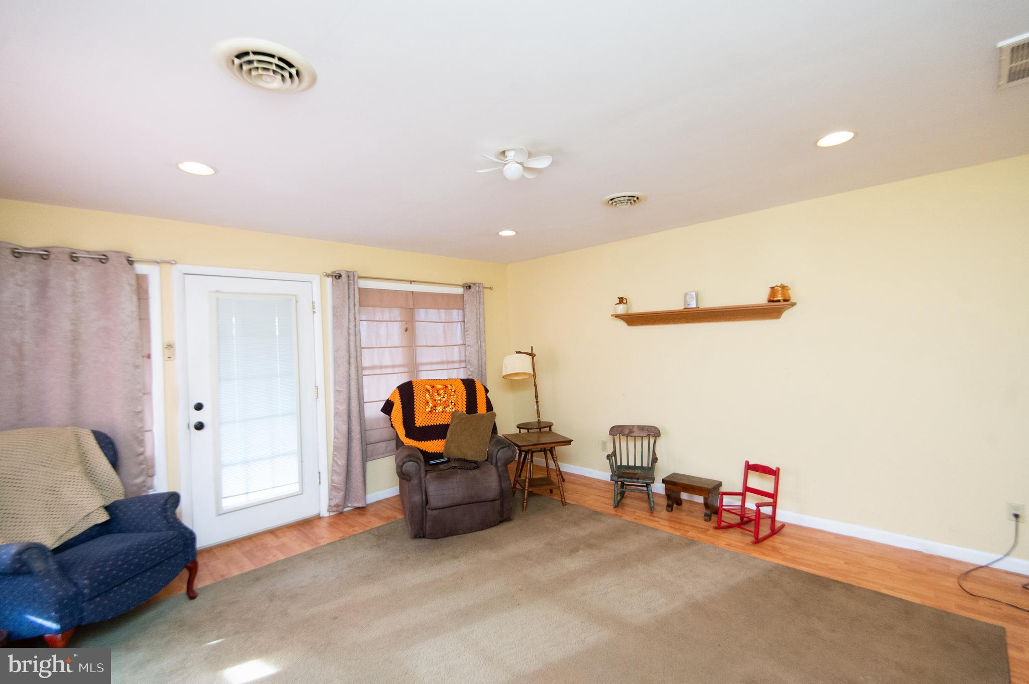 6132 Palmer Mill Road Hurlock, MD 21643 - Photo 12 of 37 a living room with furniture and a flat screen tv