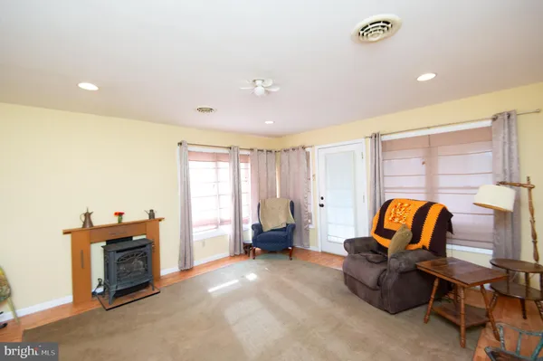 a living room with furniture and a lamp