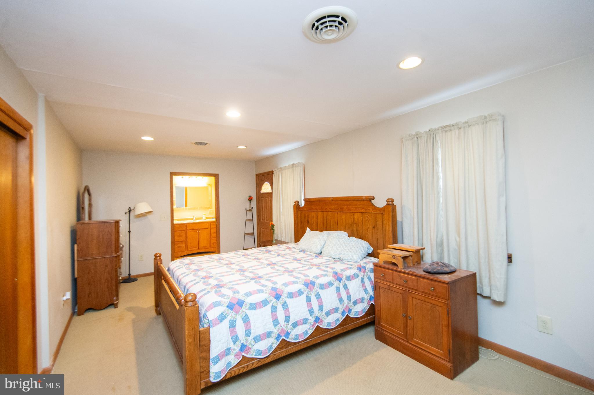 6132 Palmer Mill Road Hurlock, MD 21643 - Photo 15 of 37 a bedroom with a bed and wooden floor