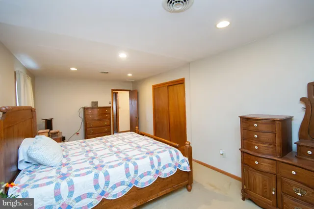 a bedroom with a bed and a dresser