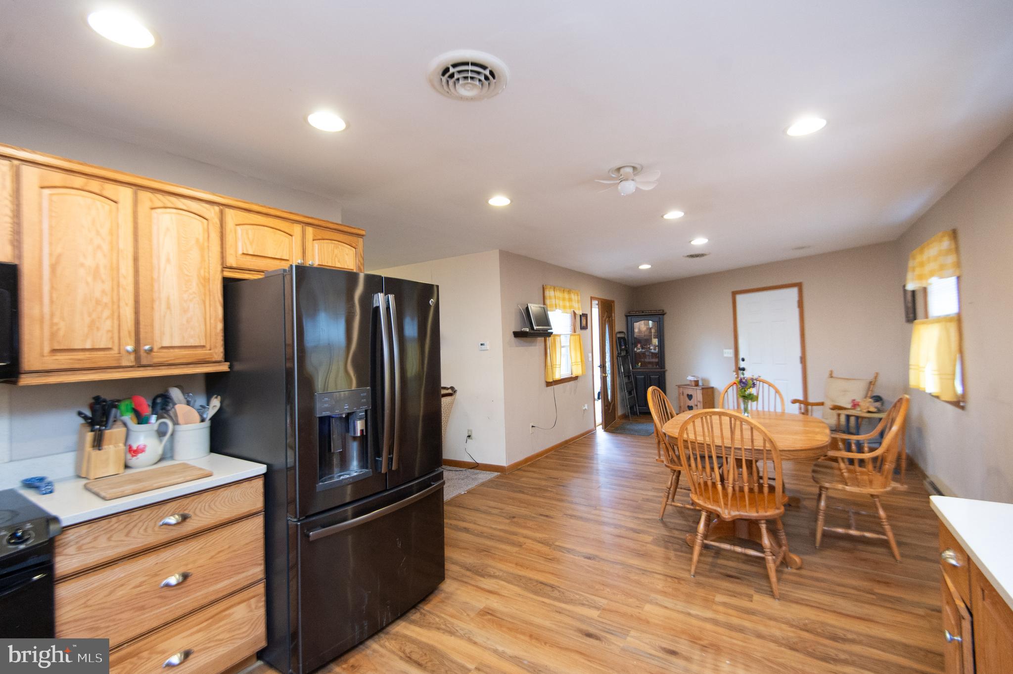 6132 Palmer Mill Road Hurlock, MD 21643 - Photo 2 of 37 a kitchen with stainless steel appliances granite countertop a refrigerator and wooden floor