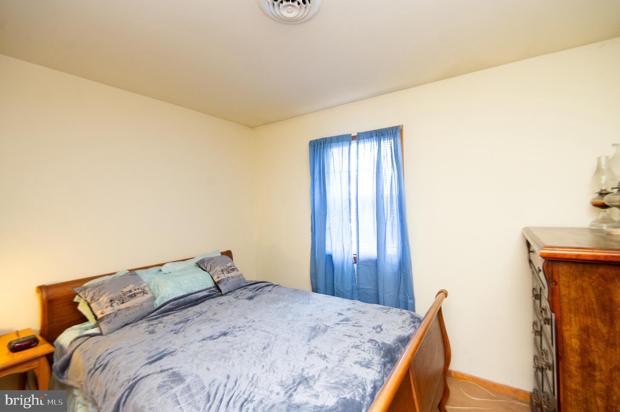 6132 Palmer Mill Road Hurlock, MD 21643 - Photo 21 of 37 a bedroom with a bed and wooden floor