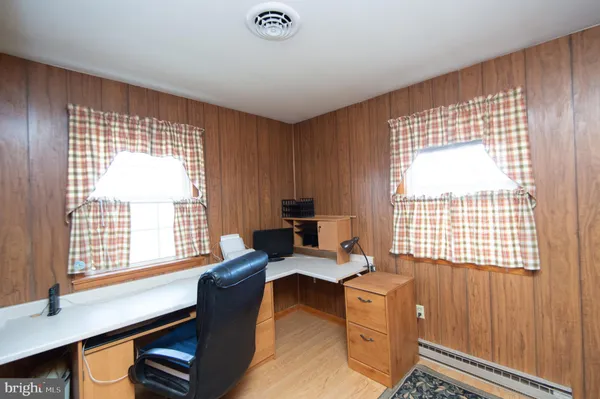 a livingroom with workspace and a window