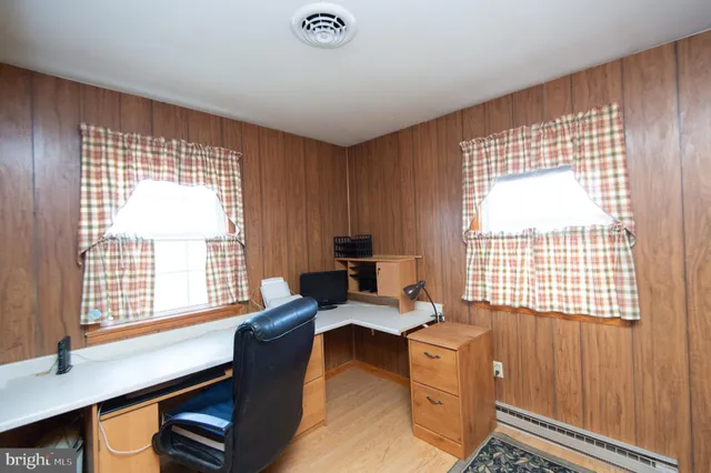 a livingroom with workspace and a window