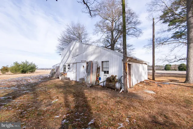 a view of a house with a yard covered in snow