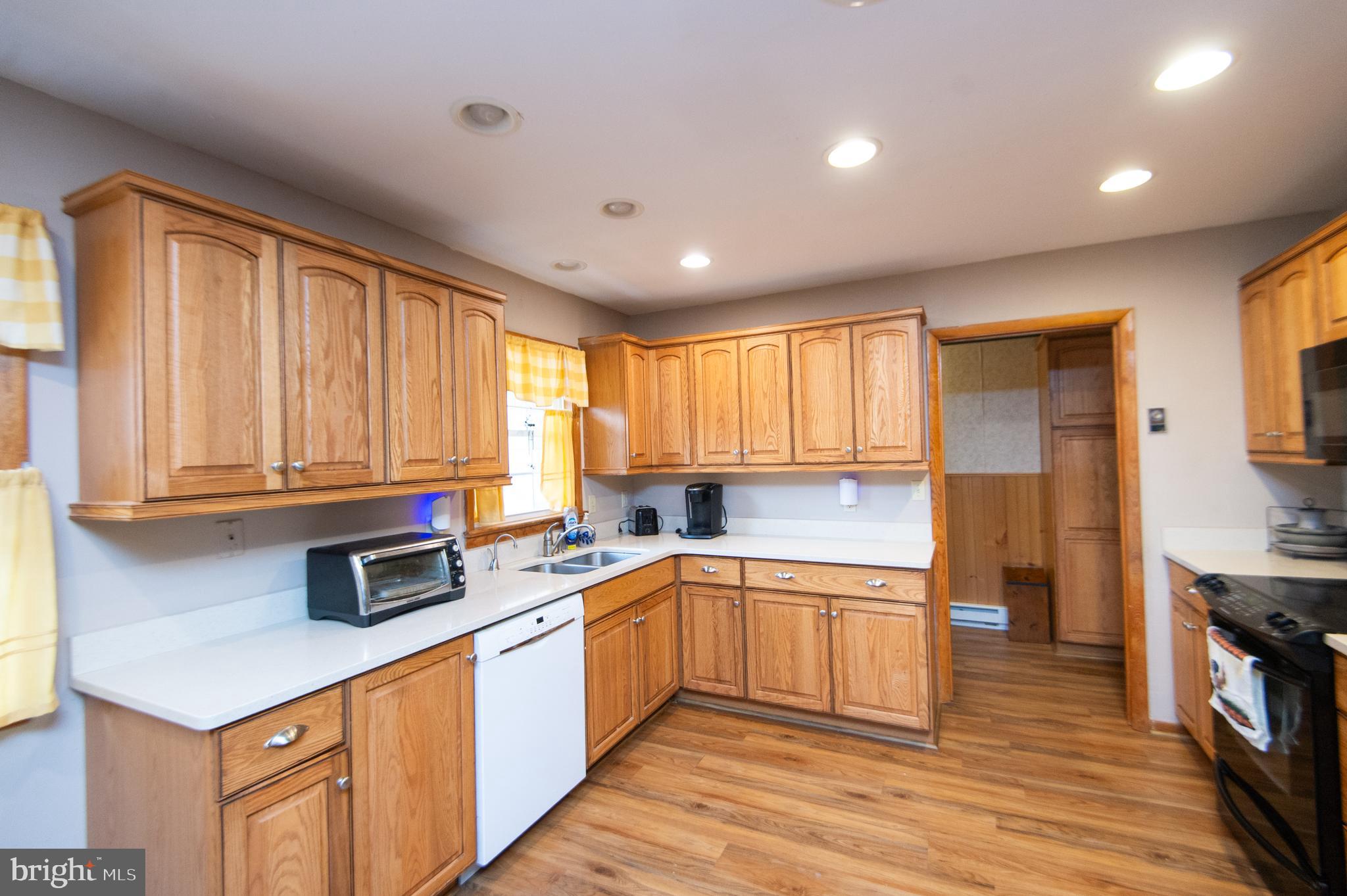 6132 Palmer Mill Road Hurlock, MD 21643 - Photo 4 of 37 a kitchen with stainless steel appliances granite countertop a sink stove and cabinets