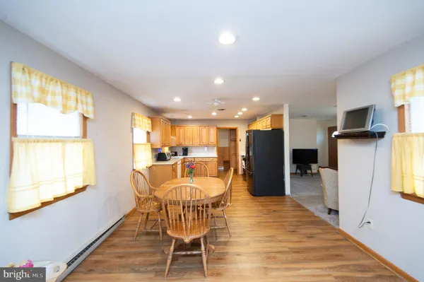 a dining room with furniture and kitchen view