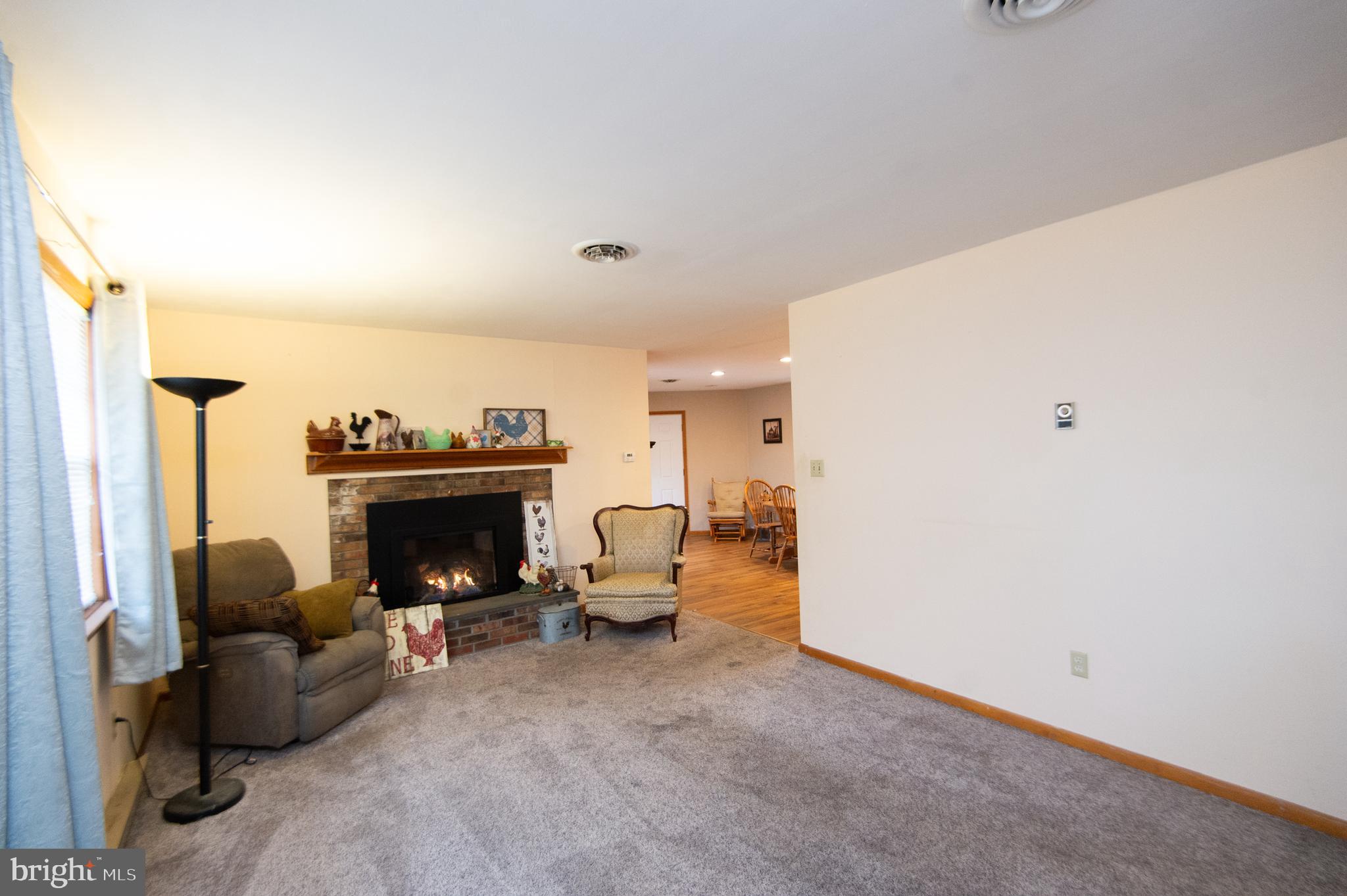 6132 Palmer Mill Road Hurlock, MD 21643 - Photo 10 of 37 a living room with furniture and a fireplace