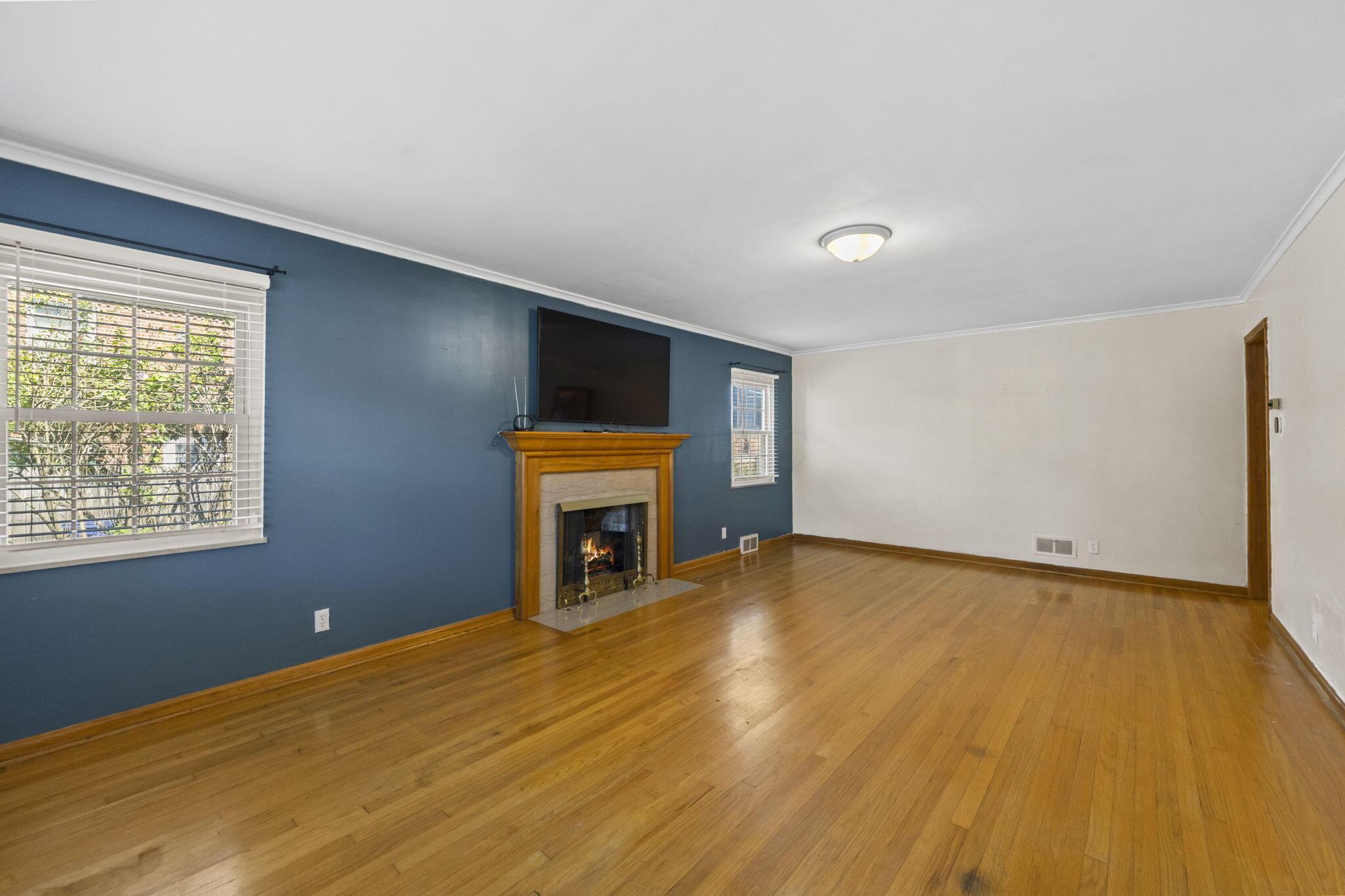 40 South Kellner Road Columbus, OH 43209 - Photo 17 of 57 Hardwood flooring throughout, featuring a wood-surround fireplace with a stone hearth, and crown molding