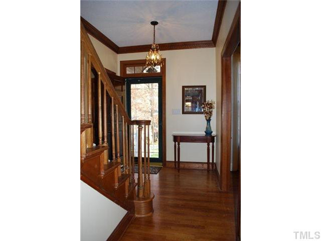 Enter foyer and be greeted by 9 foot ceilings and stunning dental molding throughout first floor. Transom window above entrance casts light on the warm, hardwood floors that flow from room to room. Foyer