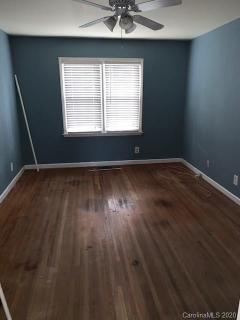 904 McAlway Road Charlotte, NC 28211 - Photo 5 of 9 an empty room with wooden floor and windows