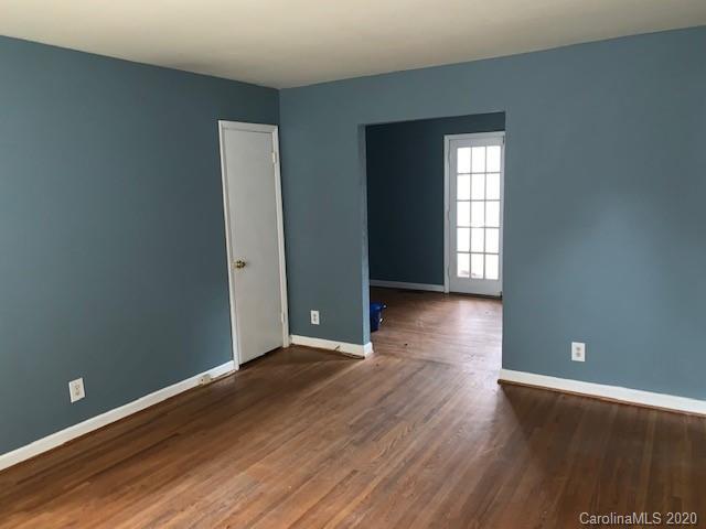 904 McAlway Road Charlotte, NC 28211 - Photo 6 of 9 an empty room with wooden floor and windows